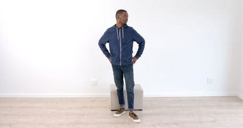 Confident Young Man in Casual Fashion in Minimalist Living Room - Download Free Stock Images Pikwizard.com