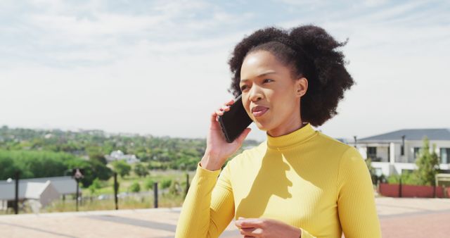 Young Woman Talking on Smartphone Outdoors on Sunny Day - Download Free Stock Images Pikwizard.com