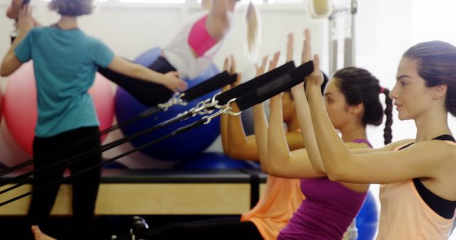 Group of Women Exercising with Resistance Bands in a Pilates Class - Download Free Stock Images Pikwizard.com