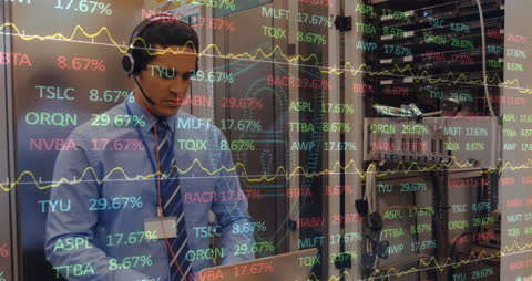 Man Analyzing Stock Market Data on Computer