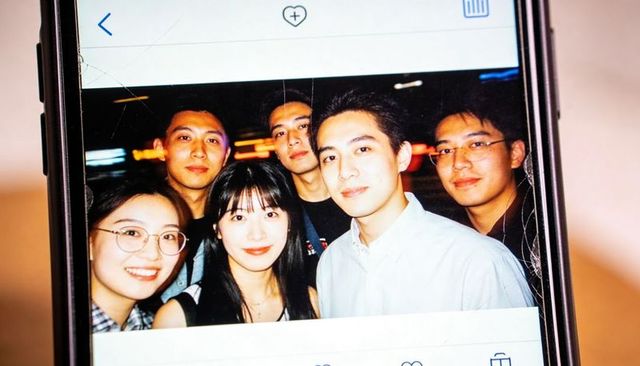 Young friends posing on cracked smartphone display capturing urban nightlife memory