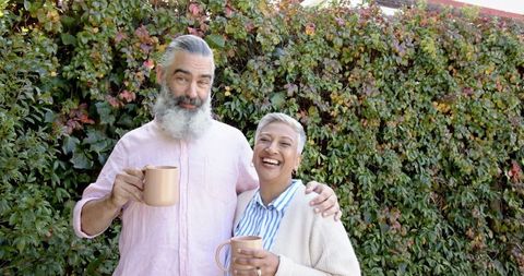 Joyful Senior Couple Enjoying Morning Coffee Outdoors