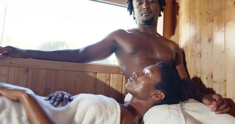 African american couple relaxing in sauna heat wooden interior intimate wellness moment