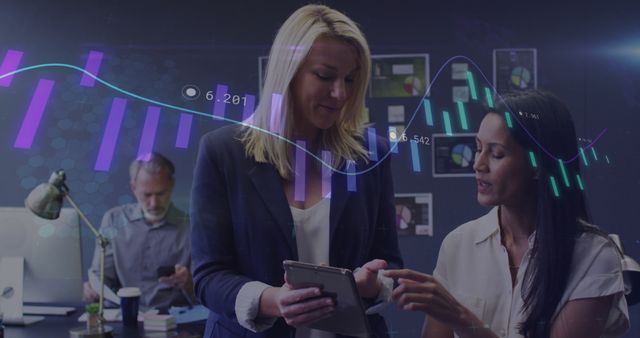 Businesswomen analyzing stock market data on digital tablet - Download Free Stock Images Pikwizard.com