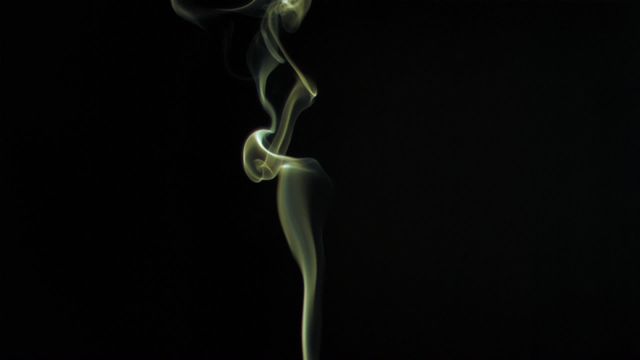 Captures swirling yellow smoke in super slow motion against a stark black background. Perfect for use in projects needing an abstract, mysterious, or ethereal feel. Ideal for backgrounds, graphics overlays, or special effects in videos.