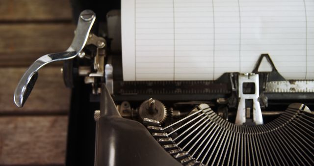 A vintage typewriter sits ready for use, with a blank sheet of paper inserted, offering a nostalgic nod to past writing technology. Its keys and mechanical parts evoke a bygone era of analog communication.