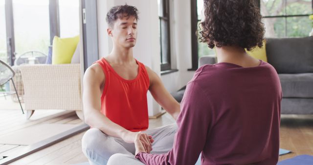 Happy diverse male couple doing yoga, meditating in living room - Download Free Stock Photos Pikwizard.com