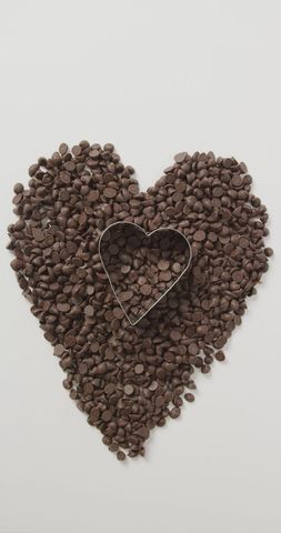 Heart-shaped chocolate chips arrangement with cookie cutter