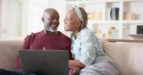 Senior Couple Joyfully Engaging with Laptop in Cozy Living Room - Download Free Stock Images Pikwizard.com