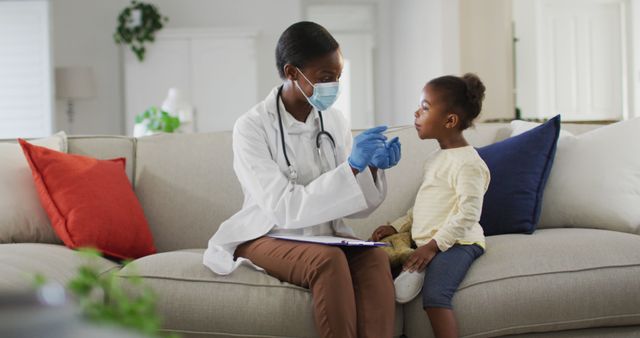 Female Doctor Checking Health of Young Girl Sitting on Sofa - Download Free Stock Images Pikwizard.com