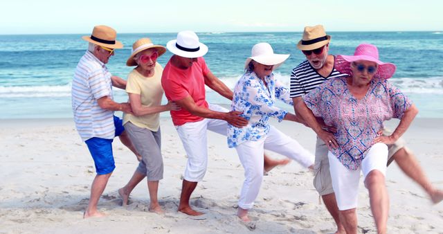 Group of elderly friends dancing playfully on a sandy beach. Ideal for concepts related to active aging, summer vacations, joyful moments, and elderly friendships. Perfect for ads promoting holidays, senior activities, and lifestyle campaigns.