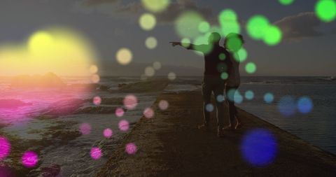 Couple Enjoying Romantic Seaside Walk at Sunset