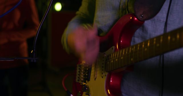 Musician Playing Electric Guitar Under Dim Lighting - Download Free Stock Images Pikwizard.com