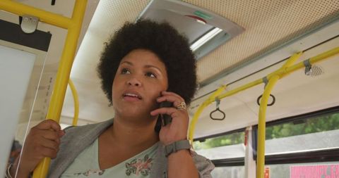 Happy Biracial Woman Talking on Phone in Bus Embracing Mobility