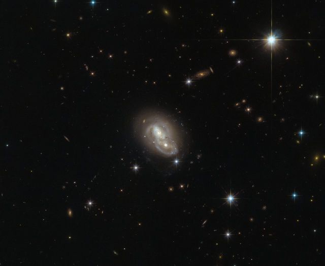 This image from the NASA/ESA Hubble Space Telescope shows the unusual galaxy IRAS 06076-2139, found in the constellation Lepus (The Hare). Hubble’s Wide Field Camera 3 (WFC3) and Advanced Camera for Surveys (ACS) instruments observed the galaxy from a distance of 500 million light-years.  This particular object stands out from the crowd by actually being composed of two separate galaxies rushing past each other at about 2 million kilometers (1,243,000 miles) per hour. This speed is most likely too fast for them to merge and form a single galaxy. However, because of their small separation of only about 20,000 light-years, the galaxies will distort one another through the force of gravity while passing each other, changing their structures on a grand scale.  Such galactic interactions are a common sight for Hubble, and have long been a field of study for astronomers. The intriguing behaviors of interacting galaxies take many forms; galactic cannibalism, galaxy harassment and even galaxy collisions. The Milky Way itself will eventually fall victim to the latter, merging with the Andromeda Galaxy in about 4.5 billion years. The fate of our galaxy shouldn’t be alarming though: while galaxies are populated by billions of stars, the distances between individual stars are so large that hardly any stellar collisions will occur.  Credit: ESA/Hubble &amp; NASA   <b><a href="http://www.nasa.gov/audience/formedia/features/MP_Photo_Guidelines.html" rel="nofollow">NASA image use policy.</a></b>  <b><a href="http://www.nasa.gov/centers/goddard/home/index.html" rel="nofollow">NASA Goddard Space Flight Center</a></b> enables NASA’s mission through four scientific endeavors: Earth Science, Heliophysics, Solar System Exploration, and Astrophysics. Goddard plays a leading role in NASA’s accomplishments by contributing compelling scientific knowledge to advance the Agency’s mission.  <b>Follow us on <a href="http://twitter.com/NASAGoddardPix" rel="nofollow">Twitter</a></b>  <b>Like us on <a href="http://www.facebook.com/pages/Greenbelt-MD/NASA-Goddard/395013845897?ref=tsd" rel="nofollow">Facebook</a></b>  <b>Find us on <a href="http://instagrid.me/nasagoddard/?vm=grid" rel="nofollow">Instagram</a></b>   