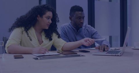 Business Colleagues Collaborating on Laptop in Modern Meeting Room