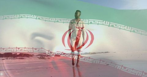 Barefoot man walking on reflective beach with iranian flag overlay and calm coastal horizon