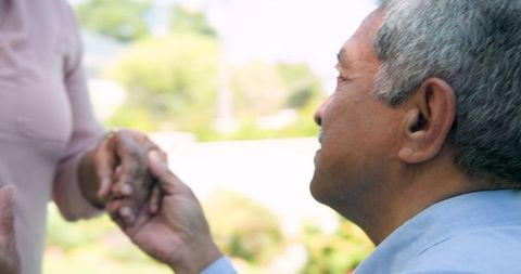 Senior Couple Celebrating Engagement on Sunny Terrace
