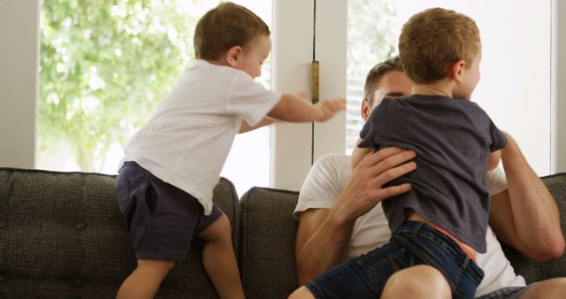 Father Playing with Young Sons on Sofa - Download Free Stock Images Pikwizard.com