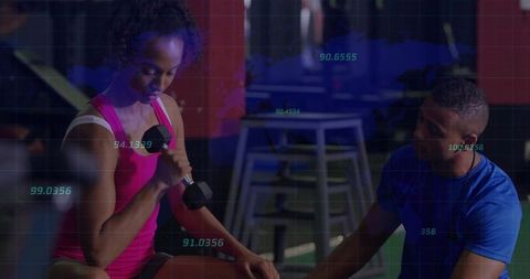 Intense gym training with dumbbell and digital metrics overlay