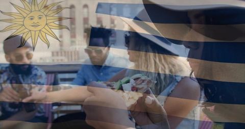 Friends enjoying pizza on rooftop terrace in vibrant urban setting