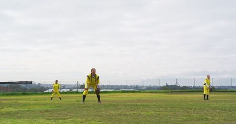Diverse Female Softball Team Practicing on Outfield