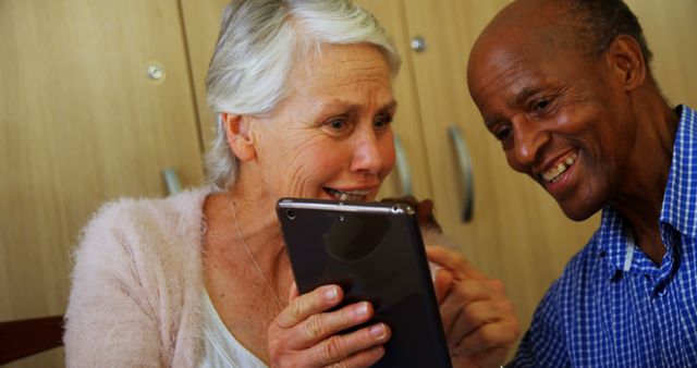 Seniors Enjoying a Tablet Together, Laughing and Sharing - Download Free Stock Images Pikwizard.com