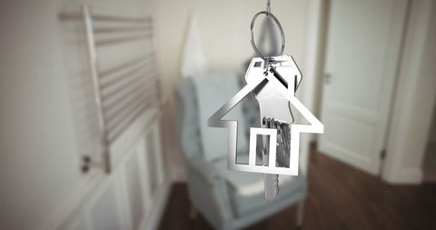 House-Shaped Keychain with Silver Keys Hanging in Modern Entryway