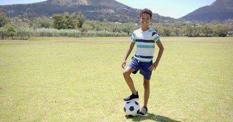 Joyful Boy Playing Soccer in Sunny Park, Displaying Active Lifestyle