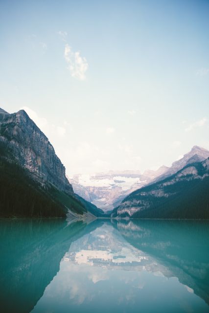 Serene Mountain Lake with Clear Reflective Water Under Blue Sky - Download Free Stock Photos Pikwizard.com