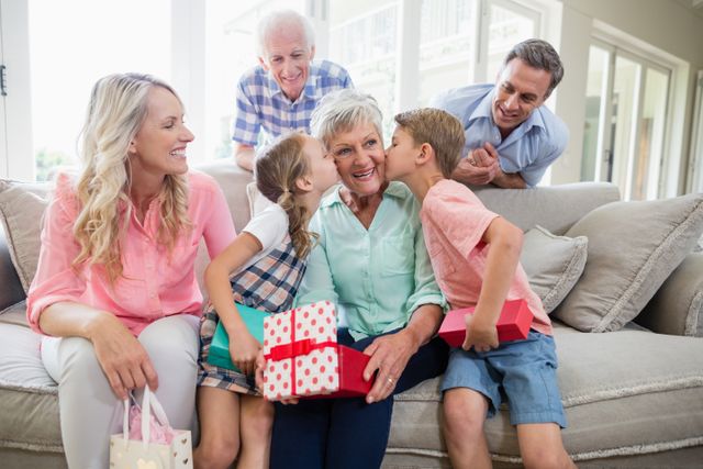 Grandmother receiving a kiss from their grandchildren in living room - Download Free Stock Photos Pikwizard.com