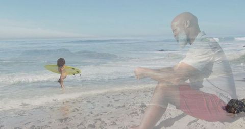 Child with surfboard and senior enjoying day at sunny beach