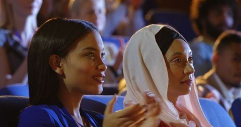 Diverse Businesswomen Applauding at Conference