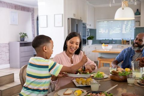 Happy Family Sharing Meal in Modern Kitchen Interior