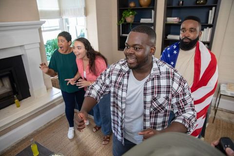 Diverse Group Enjoying Video Game at Home Gathering