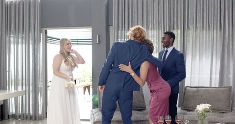 Joyful wedding toast with multiracial friends