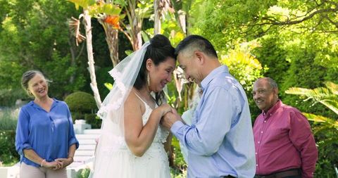 Joyful Senior Couple Exchanging Marriage Vows in Sunny Garden
