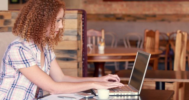 Young Woman Working on Laptop in Cafe with Coffee - Download Free Stock Images Pikwizard.com