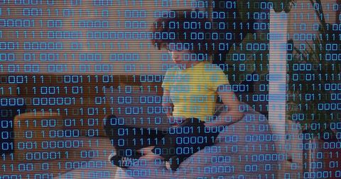 Woman sitting cross-legged on sofa reacting to offscreen sound with digital binary overlay