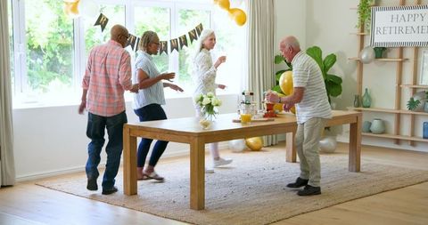 Senior friends gathering celebrating retirement at home