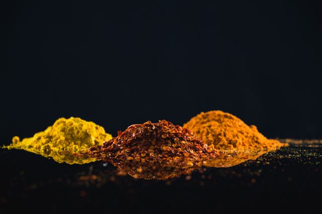 Close-Up of Colorful Powdered Spices Against Black Background - Download Free Stock Photos Pikwizard.com