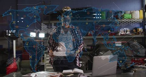 Technician wearing plaid shirt and safety goggles checking laptop with ar map overlay