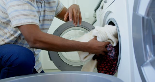 Man Loading Laundry into Washing Machine in Modern Home Laundry Room - Download Free Stock Images Pikwizard.com