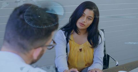 Two Colleagues Using Advanced Analytics in Office Discussion