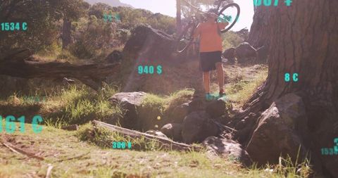 Adventurous Man Carrying Bike Through Rugged Mountain Terrain