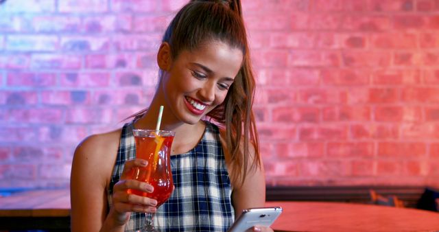 Smiling Woman Enjoying Drink While Using Smartphone in Cafe - Download Free Stock Images Pikwizard.com