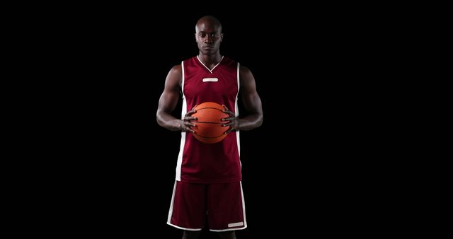 Young Male Basketball Player Holding Ball on Black Background - Download Free Stock Images Pikwizard.com