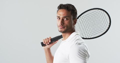 Confident Young Athlete Posing with Badminton Racket
