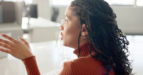 African American businesswoman speaking and gesturing during modern office meeting portrait