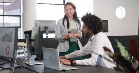 Business Colleagues Collaborating on Office Project with Laptops